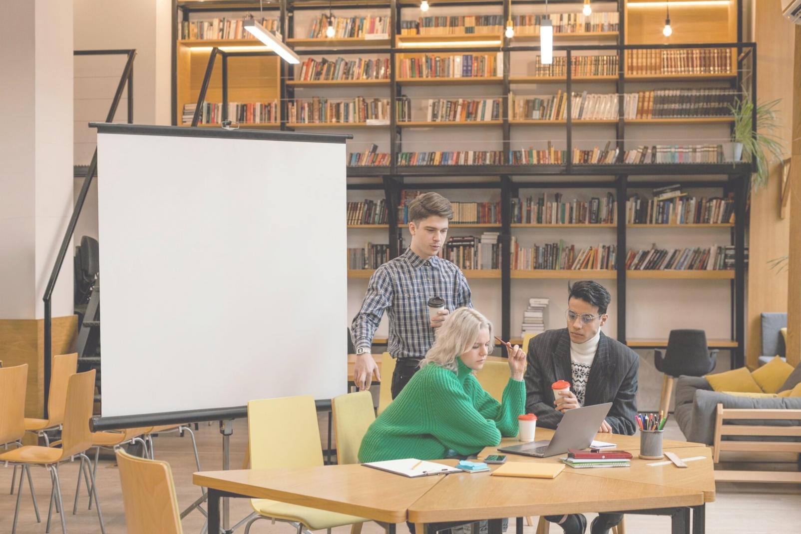 Financial analyst reviewing detailed business reports and charts on multiple screens